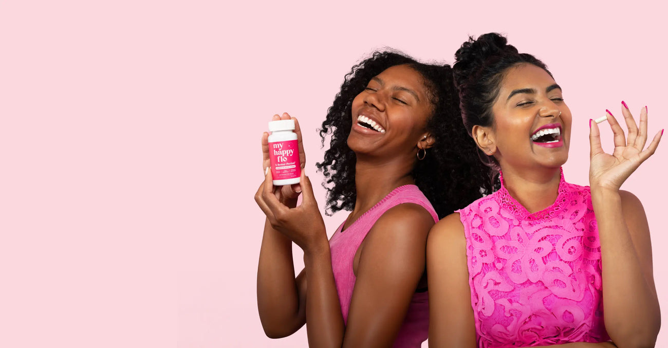 a group of women smiling and holding a bottle of vitamins
